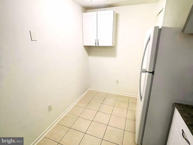 13533 Demetrias Way, Germantown, MD 20874 - kitchen featuring freestanding refrigerator, white cabinets, light tile patterned floors, and dark countertops