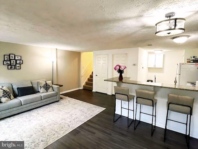 13533 Demetrias Way, Germantown, MD 20874 - living room featuring stairs, dark wood-style floors, and a textured ceiling