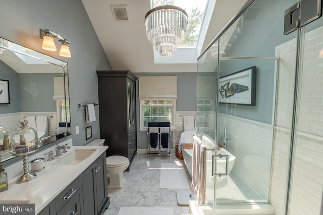 2440 Saddlebrook Rd, Macungie, PA 18062 - bathroom featuring a soaking tub, vanity, a stall shower, lofted ceiling, and toilet