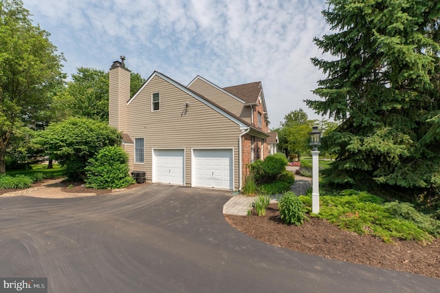 2440 Saddlebrook Rd, Macungie, PA 18062 - view of property exterior featuring asphalt driveway and a chimney