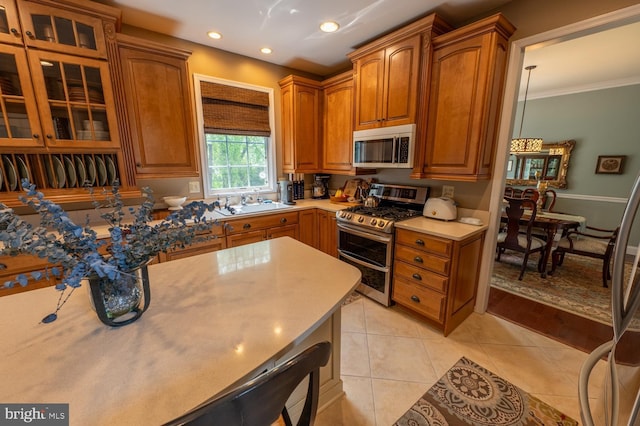2440 Saddlebrook Rd, Macungie, PA 18062 - kitchen with stainless steel appliances, light tile patterned floors, glass insert cabinets, recessed lighting, and light countertops
