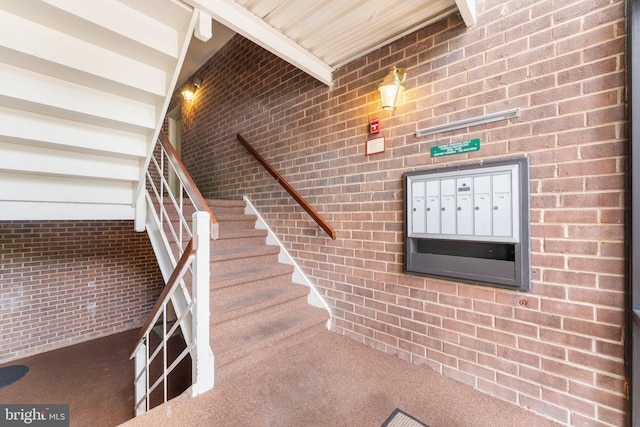 1413 Northgate Sq Unit 13/2A, Reston, VA 20190 - stairway with carpet floors, mail area, and brick wall