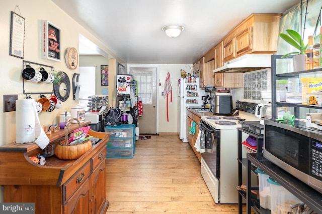 17 Clark St, Duncannon, PA 17020 - kitchen featuring white appliances, under cabinet range hood, light wood-style flooring, brown cabinets, and baseboards
