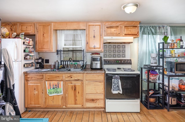 17 Clark St, Duncannon, PA 17020 - kitchen with range with electric stovetop, under cabinet range hood, freestanding refrigerator, stainless steel microwave, and light wood-style floors