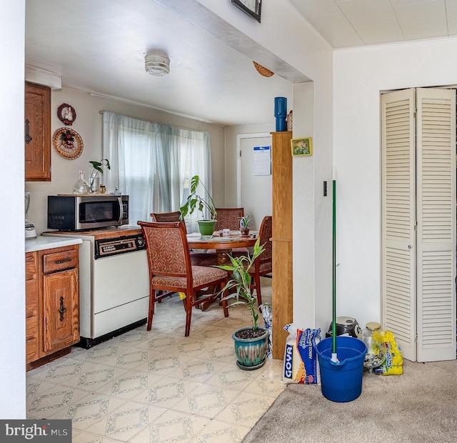 17 Clark St, Duncannon, PA 17020 - kitchen with stainless steel microwave, white dishwasher, light countertops, brown cabinets, and light floors