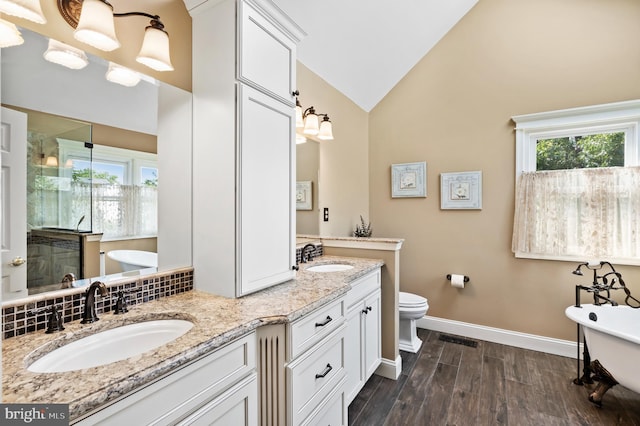 6 Windrose Cir, Doylestown, PA 18901 - full bathroom featuring a shower stall, double vanity, a freestanding bath, wood finished floors, and high vaulted ceiling