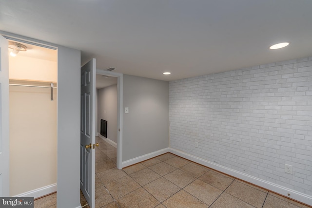 518 Scott St, Baltimore, MD 21230 - unfurnished bedroom featuring brick wall, baseboards, tile patterned flooring, recessed lighting, and a closet