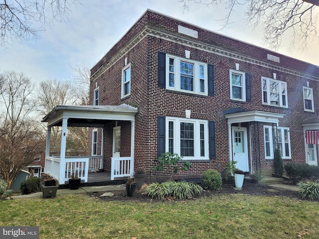 415 Sunset Rd, Reading, PA 19611 - view of front of home with brick siding, a front yard, and a porch