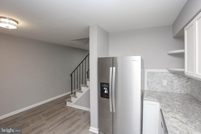 1932 Inverton Rd, Baltimore, MD 21222 - kitchen with stainless steel refrigerator with ice dispenser, open shelves, decorative backsplash, light wood-style floors, and light stone counters