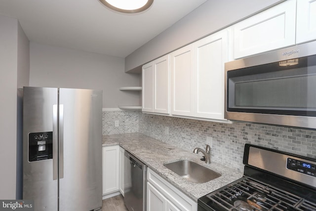 1932 Inverton Rd, Baltimore, MD 21222 - kitchen with stainless steel appliances, white cabinets, open shelves, and light stone countertops