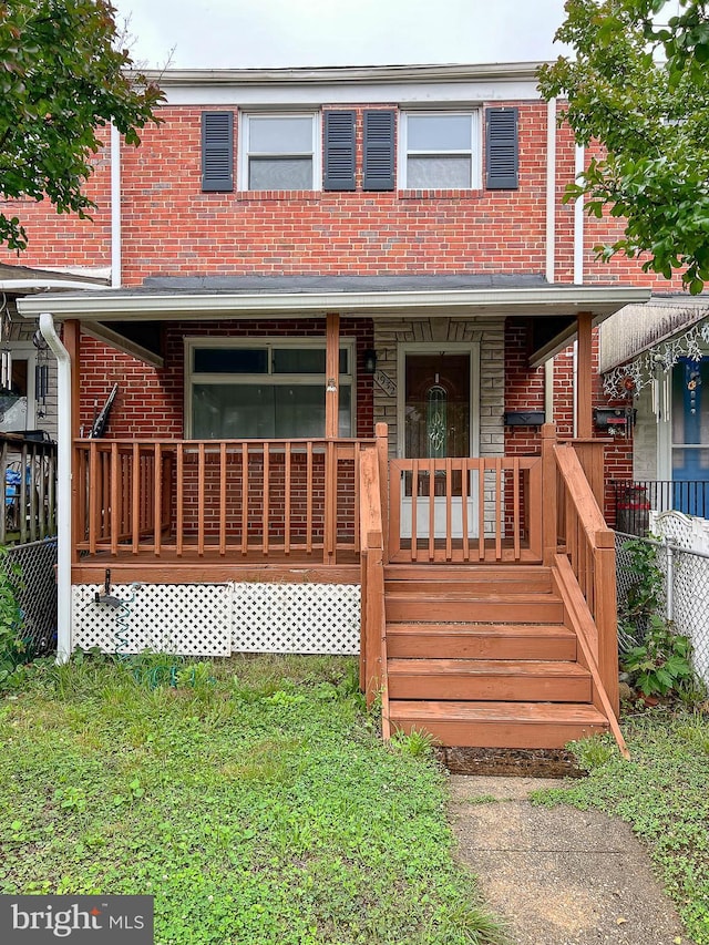 1932 Inverton Rd, Baltimore, MD 21222 - view of property featuring a porch, brick siding, and a front lawn