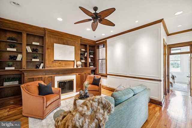 1827 Phelps Pl NW, Washington, DC 20008 - living room with a glass covered fireplace, ornamental molding, light wood-style flooring, ceiling fan, and recessed lighting
