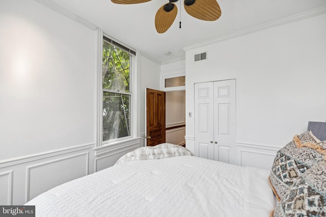 1827 Phelps Pl NW, Washington, DC 20008 - bedroom featuring a decorative wall, ornamental molding, a closet, a wainscoted wall, and a ceiling fan