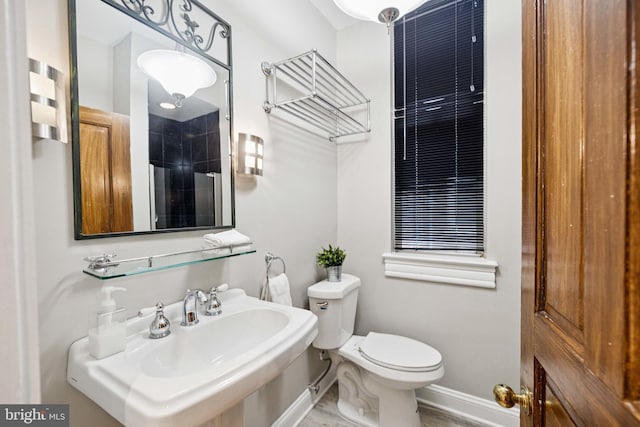 1827 Phelps Pl NW, Washington, DC 20008 - full bathroom with baseboards, toilet, a sink, and a shower
