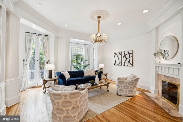 1827 Phelps Pl NW, Washington, DC 20008 - living area with light wood-style floors, a chandelier, crown molding, a fireplace, and recessed lighting