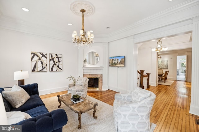 1827 Phelps Pl NW, Washington, DC 20008 - living area featuring a chandelier, ornamental molding, light wood finished floors, recessed lighting, and a high end fireplace
