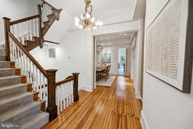 1827 Phelps Pl NW, Washington, DC 20008 - hall with light wood-style floors, a chandelier, stairway, baseboards, and ornamental molding