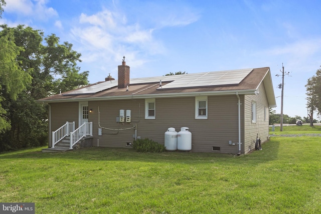 23170 Longview Blvd, Bushwood, MD 20618 - rear view of house featuring solar panels, a chimney, and a lawn