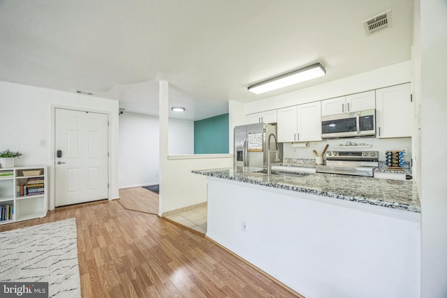 315 Coventry Ct, Mantua, NJ 08051 - kitchen featuring stainless steel appliances, a peninsula, white cabinetry, light wood-style floors, and light stone countertops