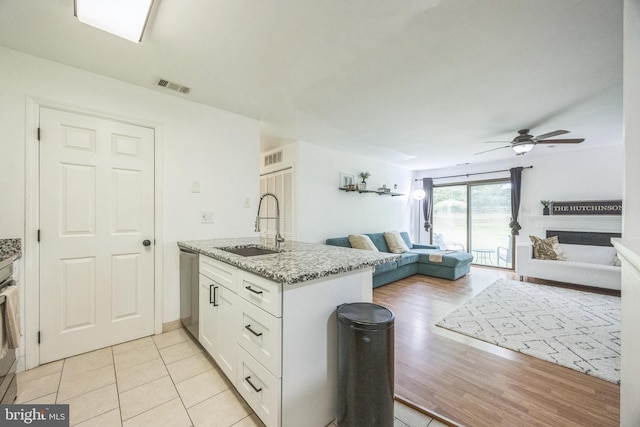 315 Coventry Ct, Mantua, NJ 08051 - kitchen featuring a sink, open floor plan, white cabinetry, ceiling fan, and light stone countertops