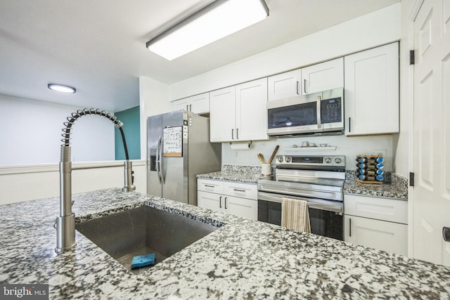 315 Coventry Ct, Mantua, NJ 08051 - kitchen featuring stainless steel appliances, a sink, light stone countertops, and white cabinets