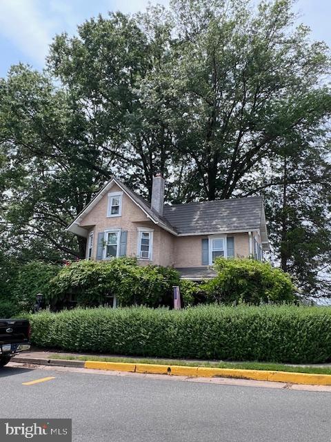 403 Center St, Pottstown, PA 19464 - view of front of house featuring a chimney and uncovered parking