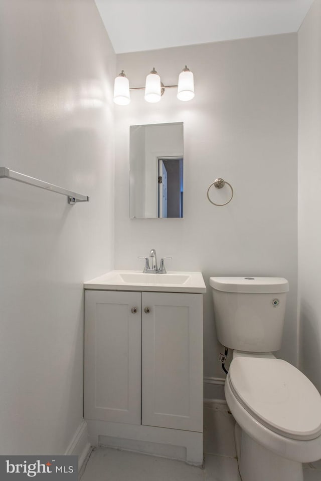 706 Cumberland St, Baltimore, MD 21217 - half bathroom with baseboards, vanity, and toilet
