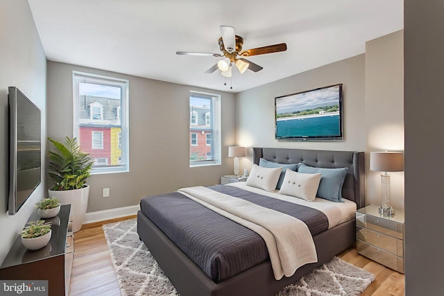 706 Cumberland St, Baltimore, MD 21217 - bedroom with light wood-style floors, baseboards, and a ceiling fan