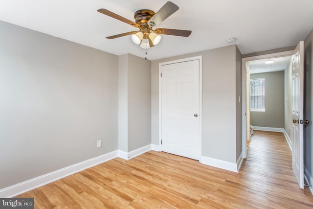 706 Cumberland St, Baltimore, MD 21217 - unfurnished bedroom with light wood finished floors, baseboards, a closet, and ceiling fan