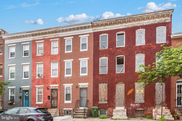 706 Cumberland St, Baltimore, MD 21217 - view of front facade featuring entry steps, brick siding, and cooling unit