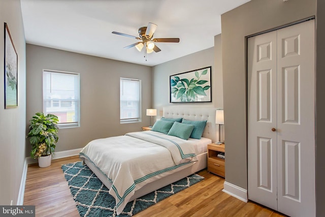 706 Cumberland St, Baltimore, MD 21217 - bedroom featuring baseboards, light wood-type flooring, a closet, and a ceiling fan