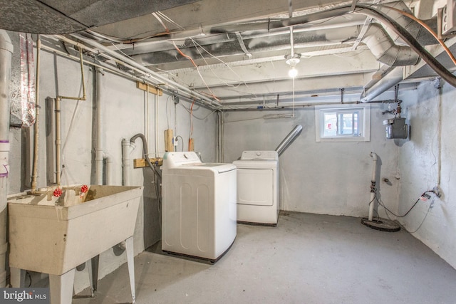 706 Cumberland St, Baltimore, MD 21217 - below grade area with washing machine and dryer, a sink, gas meter, and drainage system