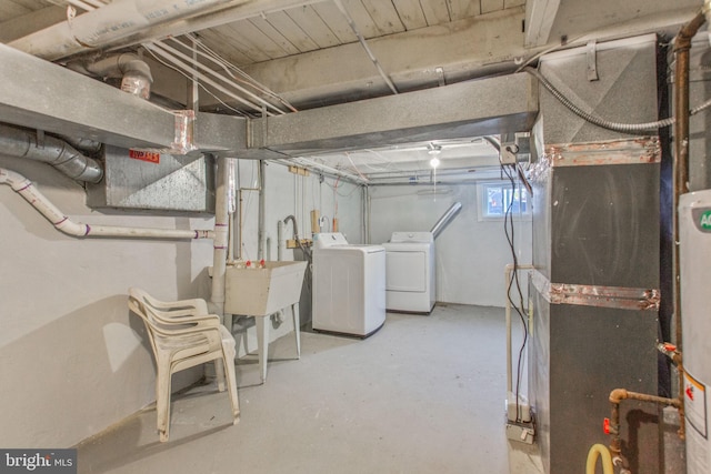 706 Cumberland St, Baltimore, MD 21217 - basement featuring washer and clothes dryer, gas water heater, and a sink