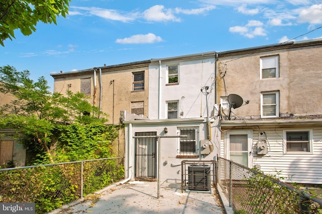 706 Cumberland St, Baltimore, MD 21217 - rear view of property with cooling unit, stucco siding, and a patio