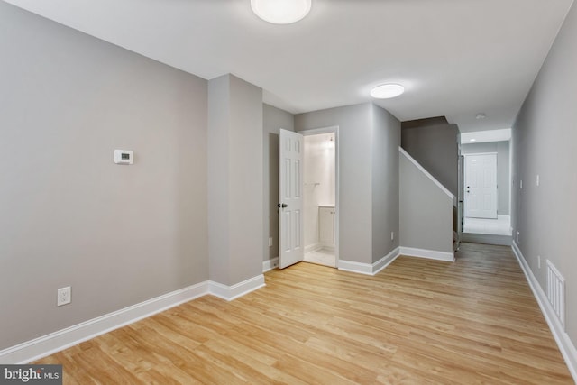 706 Cumberland St, Baltimore, MD 21217 - spare room featuring light wood-type flooring, baseboards, and stairway