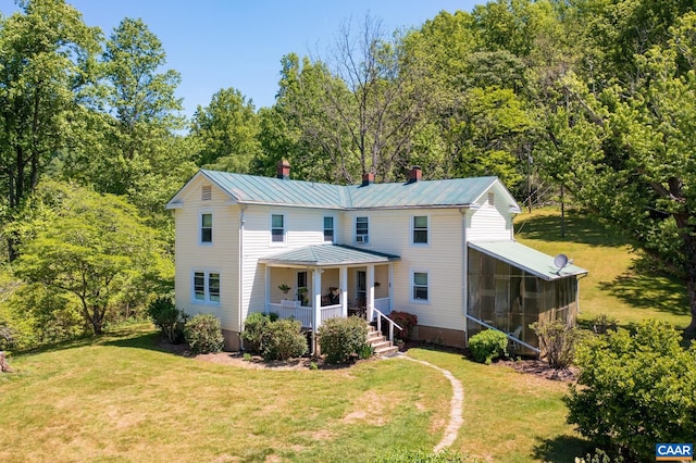 1362 Fortunes Cove Ln, Lovingston, VA 22949 - view of front facade with covered porch, a chimney, a sunroom, a front lawn, and metal roof