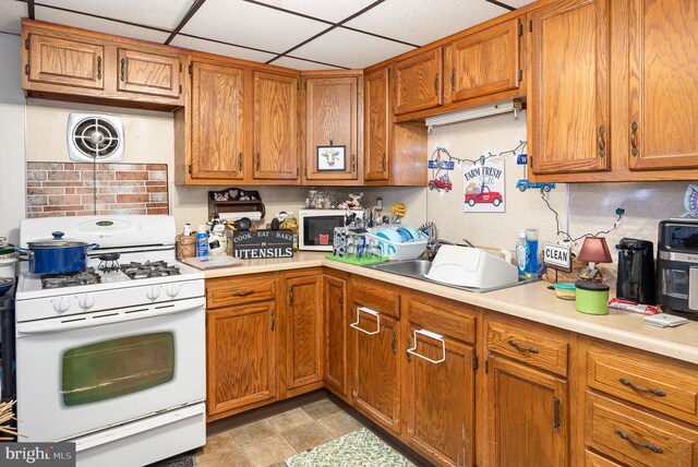 15-17 Locust St, Duncannon, PA 17020 - kitchen with white appliances, light countertops, brown cabinets, and a sink
