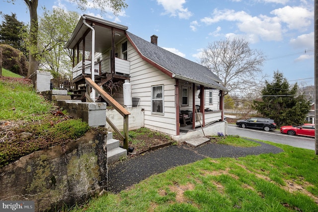 15-17 Locust St, Duncannon, PA 17020 - view of side of property with a chimney, a shingled roof, and stairs