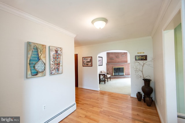 36 Algonquin Rd, Cambridge, MD 21613 - hallway with arched walkways, ornamental molding, light wood-type flooring, and baseboards