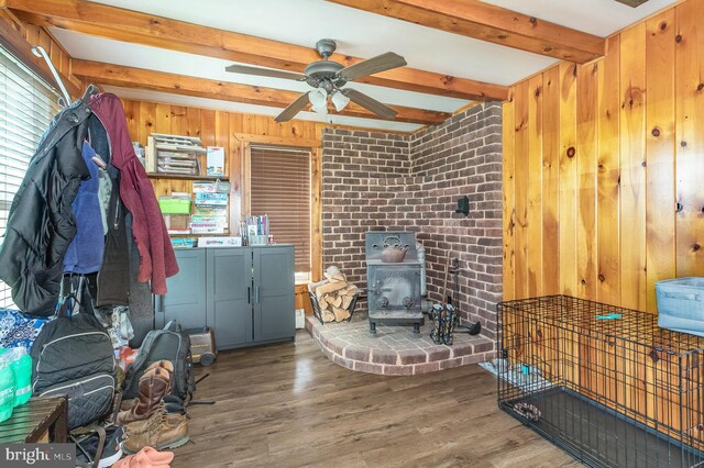 28 Laudermilch Rd, Halifax, PA 17032 - living area with beamed ceiling, a wood stove, wood walls, wood finished floors, and a ceiling fan