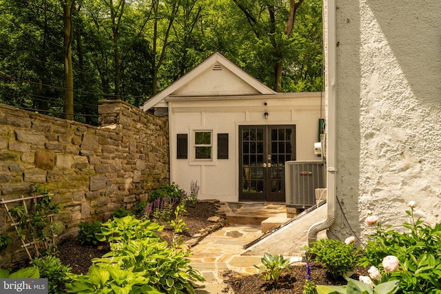 11 Conshohocken State Rd, Gladwyne, PA 19035 - entrance to property with stucco siding, french doors, cooling unit, and stone siding