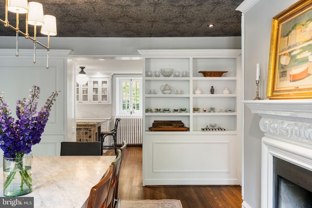 11 Conshohocken State Rd, Gladwyne, PA 19035 - dining space featuring a fireplace, dark wood finished floors, and radiator heating unit