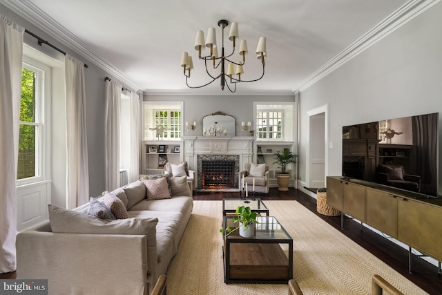 11 Conshohocken State Rd, Gladwyne, PA 19035 - living area with a high end fireplace, healthy amount of natural light, wood finished floors, crown molding, and a chandelier