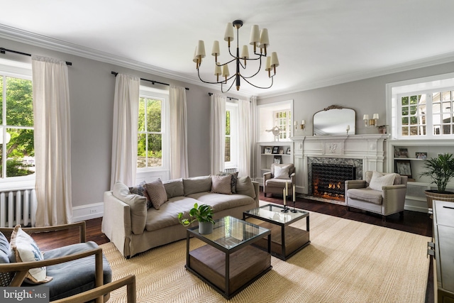 11 Conshohocken State Rd, Gladwyne, PA 19035 - living area featuring a fireplace, a chandelier, crown molding, wood finished floors, and baseboards