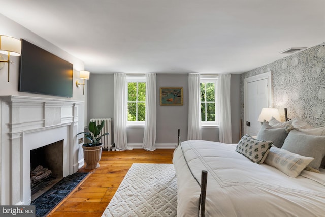 11 Conshohocken State Rd, Gladwyne, PA 19035 - bedroom with radiator heating unit, hardwood / wood-style floors, a fireplace with flush hearth, and baseboards