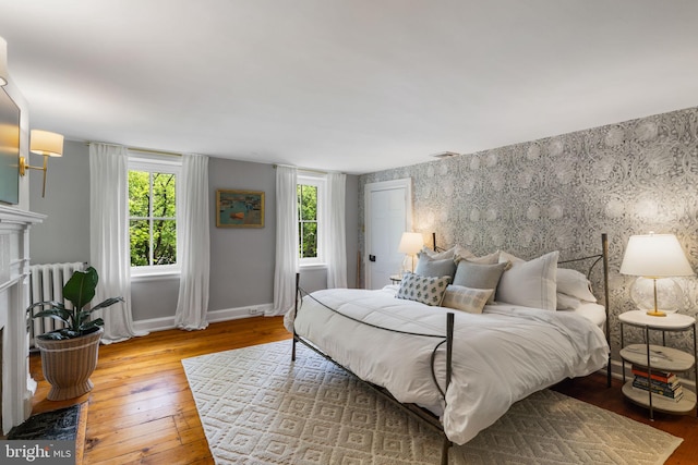 11 Conshohocken State Rd, Gladwyne, PA 19035 - bedroom featuring hardwood / wood-style floors, multiple windows, a fireplace with flush hearth, and baseboards