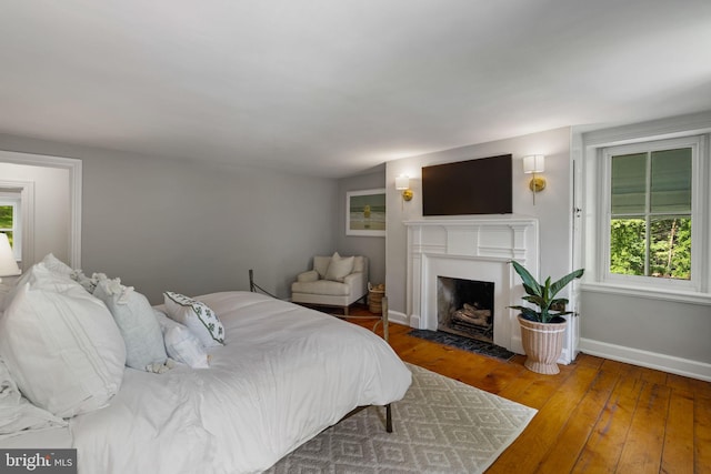 11 Conshohocken State Rd, Gladwyne, PA 19035 - bedroom featuring hardwood / wood-style floors, multiple windows, baseboards, and a fireplace with flush hearth
