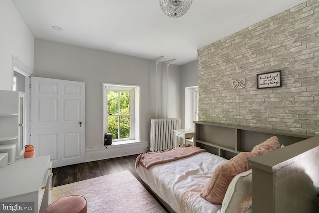 11 Conshohocken State Rd, Gladwyne, PA 19035 - bedroom featuring radiator heating unit, brick wall, and wood finished floors