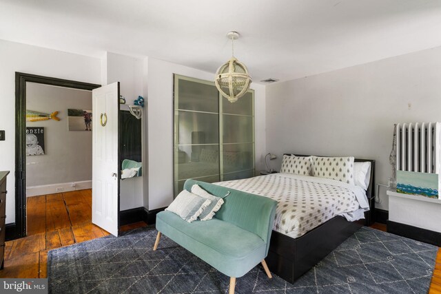 11 Conshohocken State Rd, Gladwyne, PA 19035 - bedroom featuring hardwood / wood-style floors, baseboards, radiator, and a chandelier