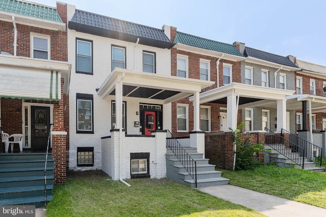1607 Saint Stephens St, Baltimore, MD 21216 - townhome / multi-family property with a porch, brick siding, and mansard roof